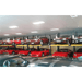 BendPak PL6000DC 6,000lb Vehicle Storage Lift - Narrow Front View All Red Cars