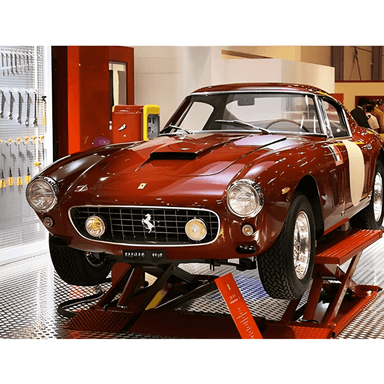 Omer MINI 30 6,600lb Mid Rise Scissor Lift Front View with red Car