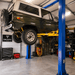 TP9KACX 9,000lb 2 Post Car Lift Clear Floor - Asymmetric Side View with Car Lifting